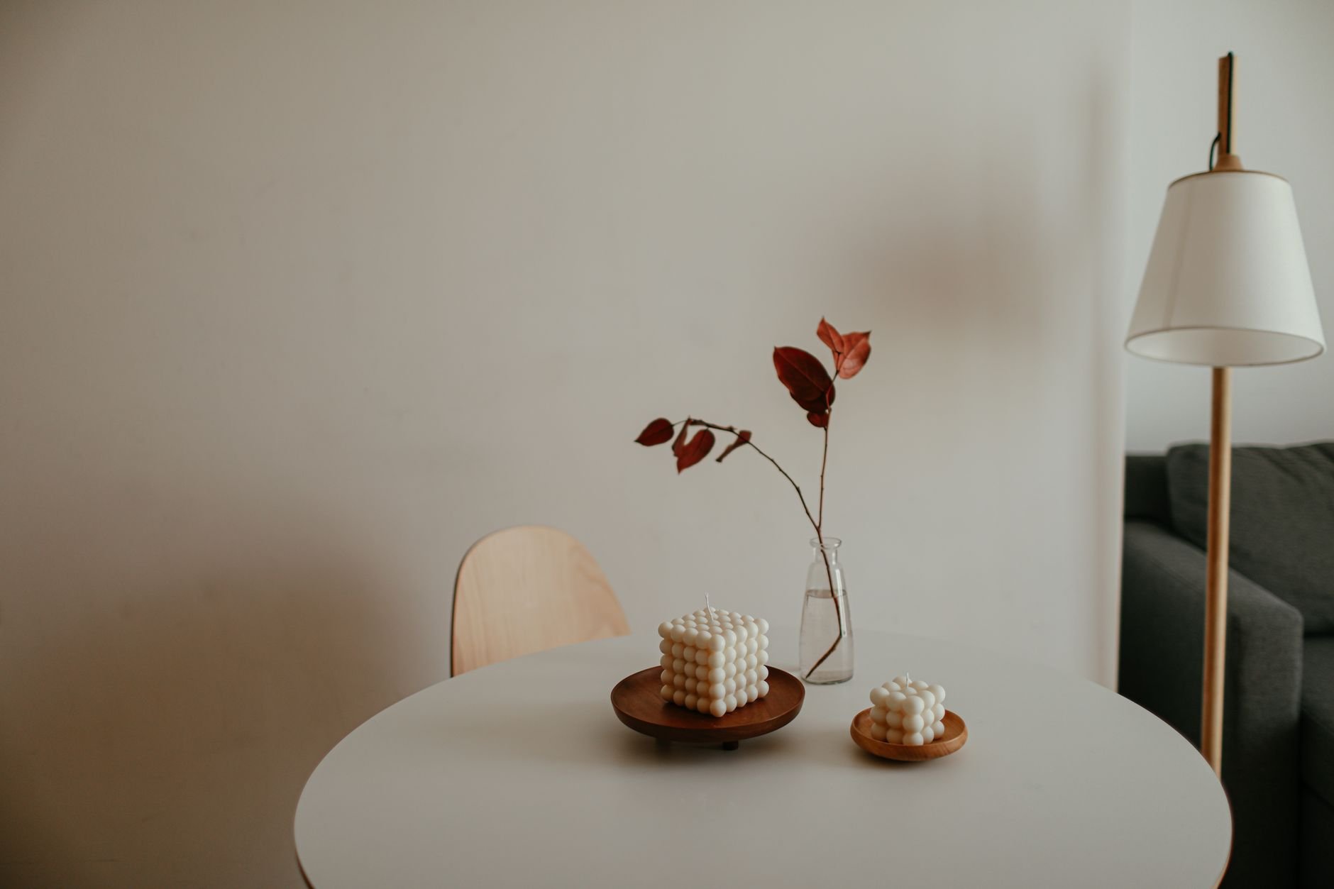 Minimalist interior with decorative candles on a table, perfect for cozy home inspiration